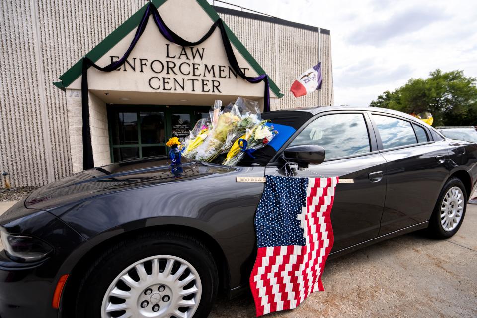 A memorial is set up outside the Kossuth County Law Enforcement Center after the Wednesday night death of Algona police officer Kevin Cram on Thursday, September 14, 2023 in Algona.