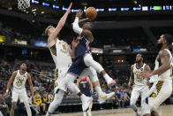 Washington Wizards guard Bradley Beal, center right, shoots over Indiana Pacers forward Domantas Sabonis (11) during the first half of an NBA basketball game in Indianapolis, Monday, Dec. 6, 2021. (AP Photo/AJ Mast)