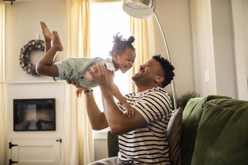 Father and daughter laughing while playing together