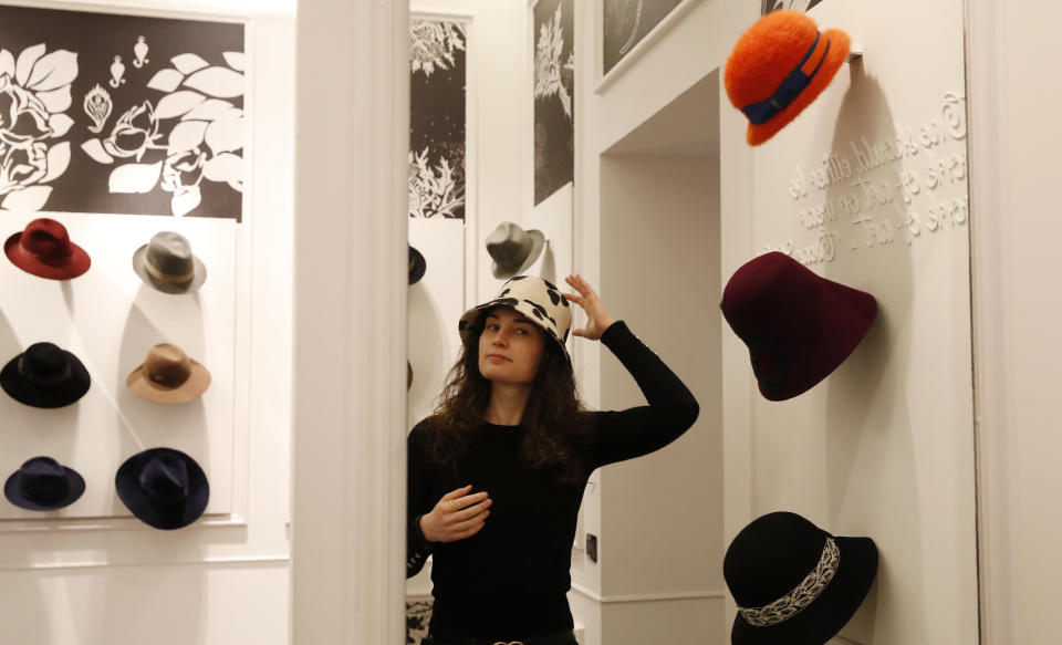 A girl wears a creation as part of the Borsalino women's Fall Winter 2021-22 collection, unveiled during the Fashion Week in Milan, Italy, Wednesday, Feb. 24, 2021. (AP Photo/Antonio Calanni)