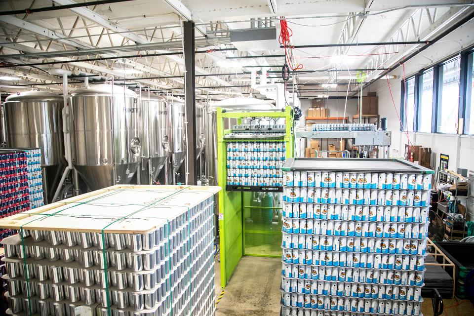 Soon-to-be filled cans are stacked up before canning, Tuesday, June 29, 2021, at Big Grove Brewery & Taproom in Iowa City, Iowa.