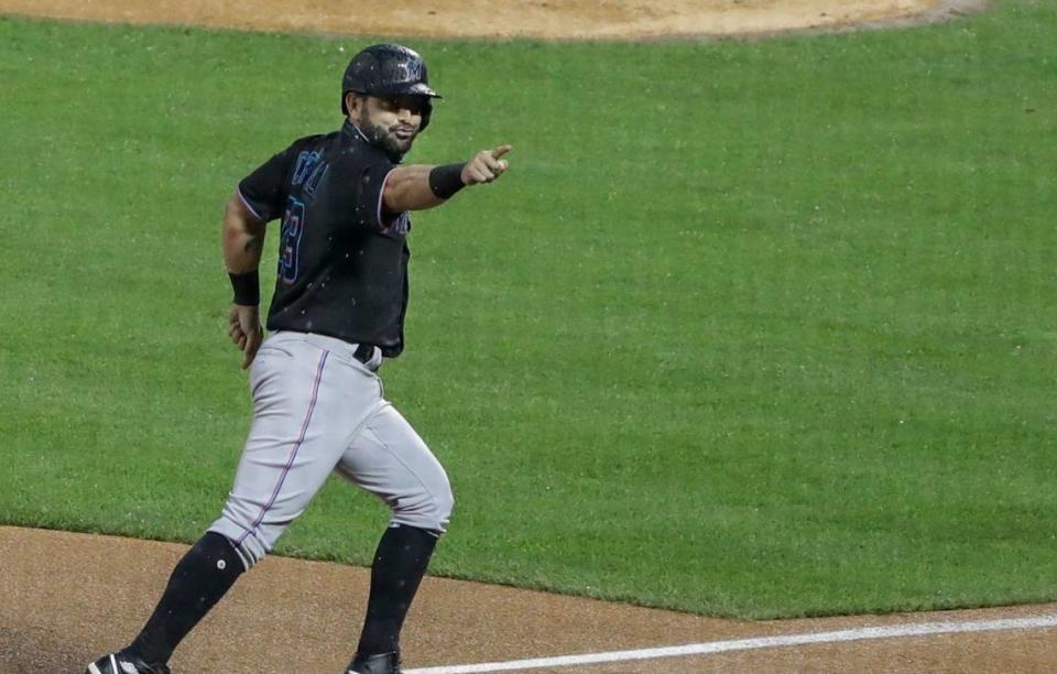 Miami Marlins’ Francisco Cervelli gestures to teammates as he runs the bases after hitting a three-run home run during the second inning of a baseball game as New York Mets starting pitcher Michael Wacha, right, reacts Friday, Aug. 7, 2020, in New York. (AP Photo/Frank Franklin II)