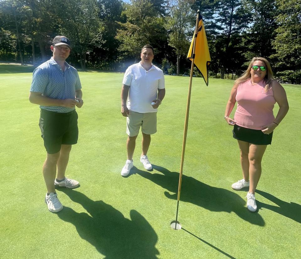 From left, Patrick Hanlon, Greg Jouki and Lauren Birkbeck stand on the fifth green at Tatnuck CC where they all carded holes in one on the par-4 hole within a month of each other.