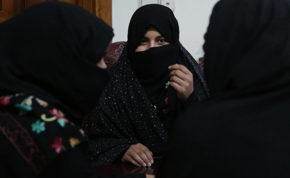 In this Monday, Feb. 18, 2019, photo, Alissa, who faced domestic violence, center, speaks during an interview with the Associated Press at a women's shelter office in Herat, Afghanistan. Women have made gains since the 2001 fall of the Taliban, but the country remains almost the worst places in the world to be a woman. Activists fear the advances they have achieved will be bargained away in negotiations, with pressure heavy for a deal as the United States seeks to end its military involvement in the country.(AP Photo/Rahmat Gul)