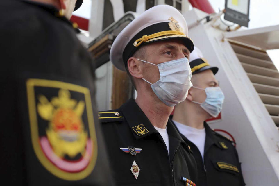 In this photo released Tuesday, Feb. 16, 2021, by the Iranian army, a Russian commander, stands during a welcoming ceremony for a joint naval exercise with the Iranian navy and Iran's Revolutionary Guard navy. Iranian and Russian militaries have kicked off a joint naval drill in the Indian Ocean aimed at boosting security of maritime trade in the region, Iran's state TV reported on Tuesday. (Iranian Army via AP)