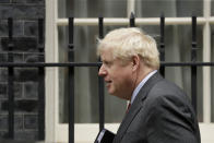 British Prime Minister Boris Johnson walks to get in a car as he leaves 10 Downing Street, in London, to go to the Houses of Parliament to make a statement on new coronavirus restrictions Tuesday, Sept. 22, 2020. Johnson plans to announce new restrictions on social interactions Tuesday as the government tries to slow the spread of COVID-19 before it spirals out of control. (AP Photo/Matt Dunham)