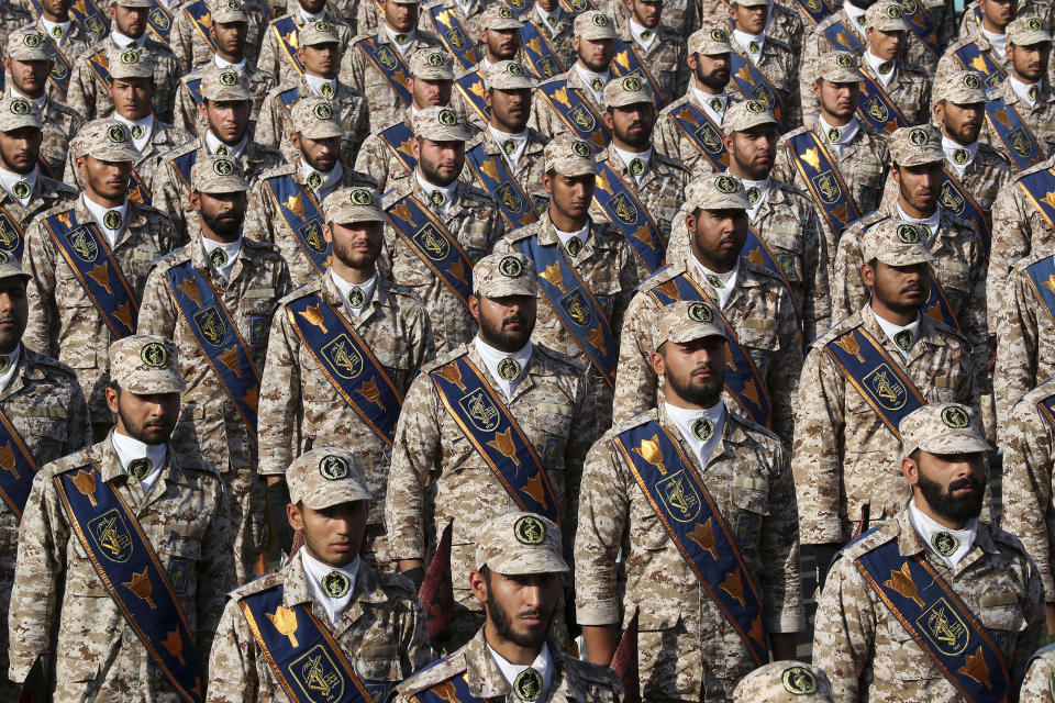 In this photo released by the official website of the office of the Iranian Presidency, Revolutionary Guard troops attend a military parade marking 39th anniversary of outset of Iran-Iraq war, in front of the shrine of the late revolutionary founder Ayatollah Khomeini, just outside Tehran, Iran, Sunday, Sept. 22, 2019. (Iranian Presidency Office via AP)