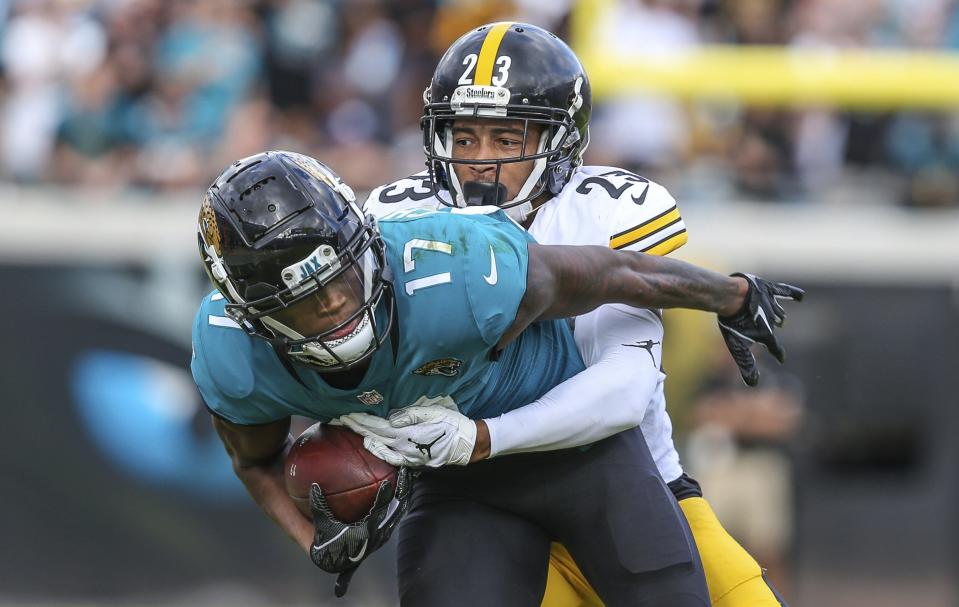 Jaguars wide receiver D.J. Chark is brought down by Joe Haden of Pittsburgh in a 2018 game in Jacksonville. Haden is among the inductees into the Florida-Georgia Hall of Fame on Oct. 27.