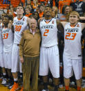 FILE - In this March 2, 2013, file photo, oil tycoon and Oklahoma State supporter T. Boone Pickens, center, celebrates with Oklahoma State's basketball team members Marcus Smart (33), Mason Cox (30), Le'Bryan Nash (2) and Alex Budke, right, following the team's win over Texas in an NCAA college basketball game in Stillwater, Okla. Pickens, a brash and quotable oil tycoon who grew even wealthier through corporate takeover attempts, died Wednesday, Sept. 11, 2019. He was 91. (AP Photo/Brody Schmidt, File)