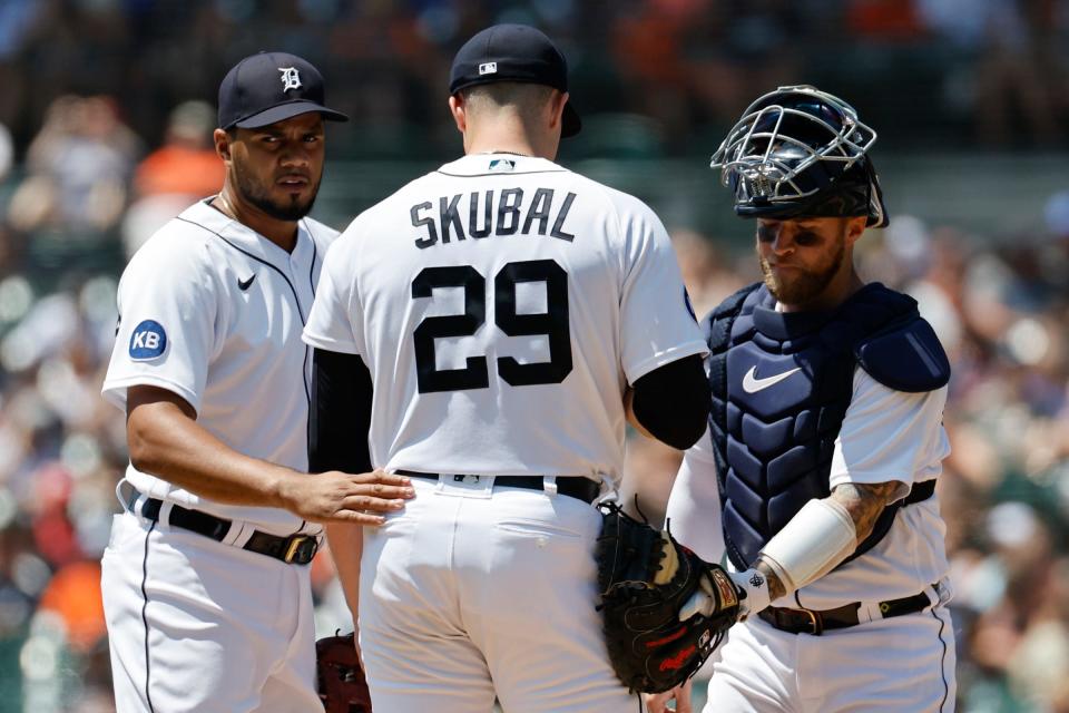 Detroit Tigers third baseman Jeimer Candelario (46) and catcher Tucker Barnhart (15) talk to starting pitcher Tarik Skubal (29) during the second inning against the Kansas City Royals at Comerica Park.