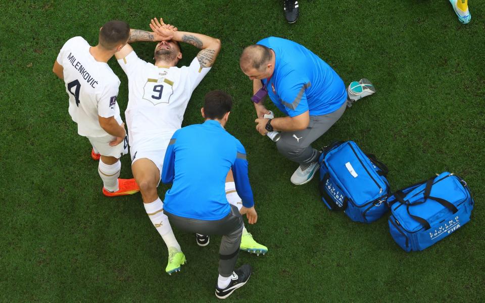 Serbia's Aleksandar Mitrovic receives medical attention after sustaining an injury - REUTERS