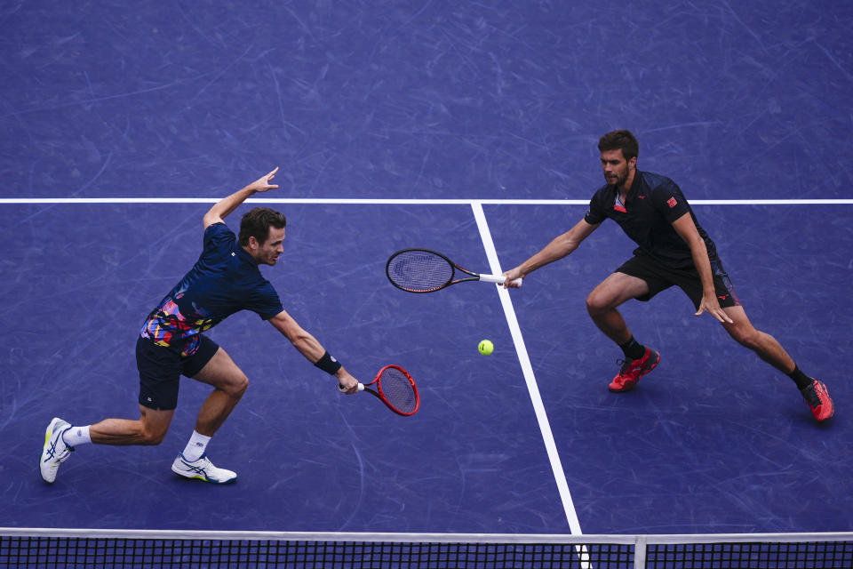 Wesley Koolhof, of the Netherlands, left, and Nikola Mektic, of Croatia, both reach for a return during their doubles final match against Marcel Granollers, of Spain, and Horacio Zeballos, of Argentina, at the BNP Paribas Open tennis tournament, Friday, March 15, 2024, in Indian Wells, Calif. (AP Photo/Ryan Sun)