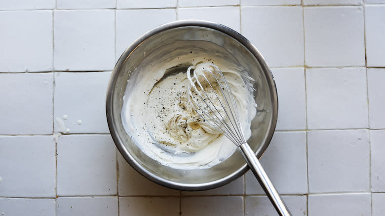 savory whipped cream in bowl with whisk