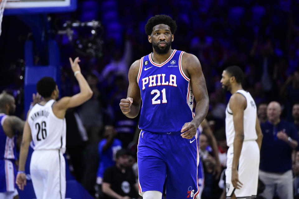 Philadelphia 76ers' Joel Embiid reacts after a score by Tobias Harris in the first half during Game 2 in the first round of the NBA basketball playoffs against the Brooklyn Nets, Monday, April 17, 2023, in Philadelphia. (AP Photo/Derik Hamilton)