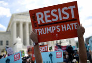 <p>Protesters hold up signs that read ‘We Will Resist Trump’s Hate’ against U.S. President Trump’s travel ban gather outside the U.S. Supreme Court as the court issued an immigration ruling June 26, 2018 in Washington, D.C. (Photo: Win McNamee/Getty Images) </p>