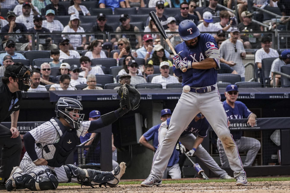 Texas Rangers' Marcus Semien, right, pulls back from a close pitch during the second inning of a baseball game against the New York Yankees, Sunday, June 25, 2023, in New York. (AP Photo/Bebeto Matthews)