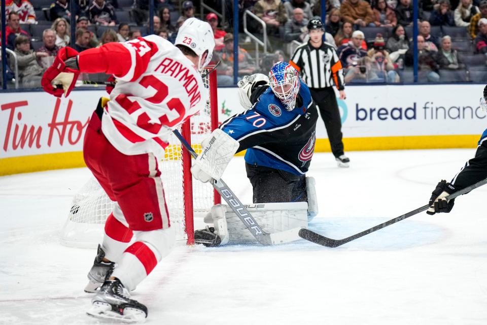 Dec 4, 2022; Columbus, Ohio, United States;  Detroit Red Wings forward Lucas Raymond (23) scores against Columbus Blue Jackets goaltender Joonas Korpisalo (70) during the second period of the NHL hockey game between the Columbus Blue Jackets and the Detroit Red Wings at Nationwide Arena on Sunday night. Mandatory Credit: Joseph Scheller-The Columbus Dispatch