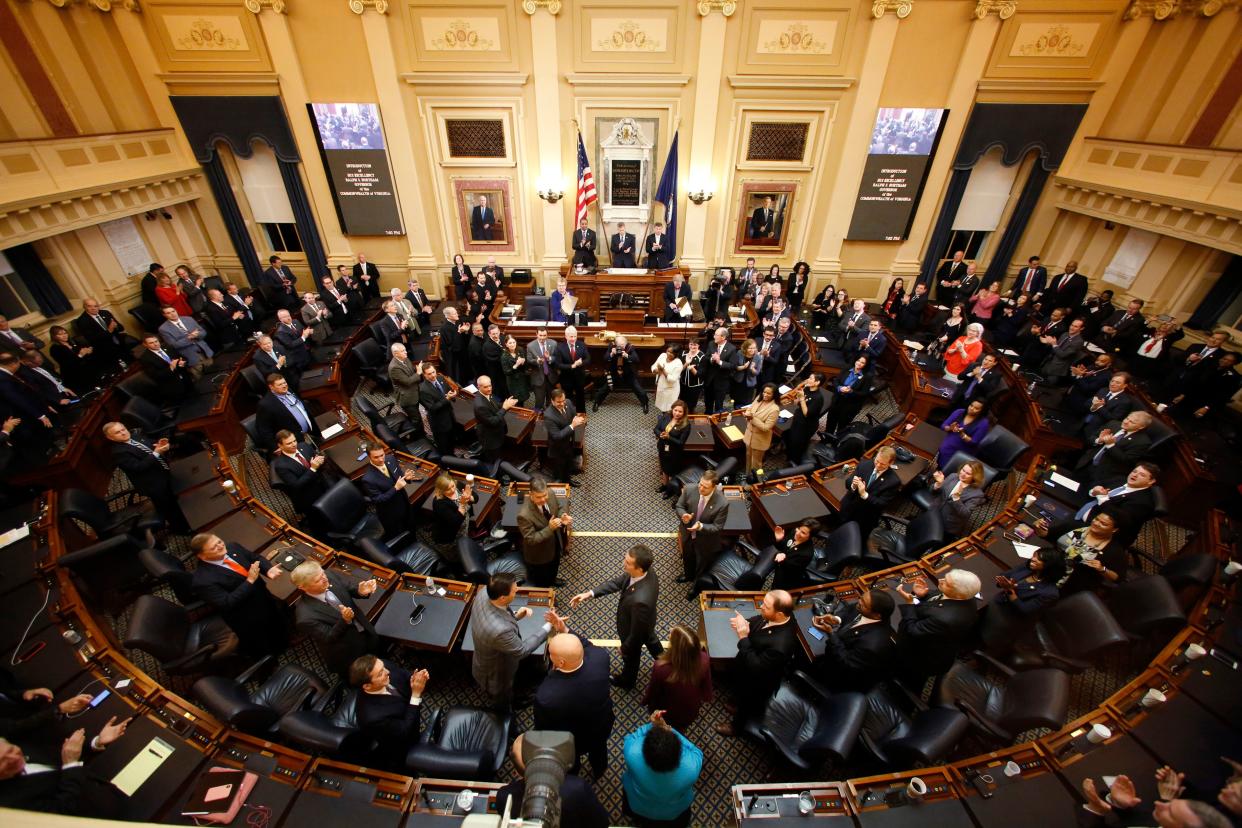 In this Wednesday, Jan. 9, 2019 file photo, Gov. Ralph Northam, center, arrives to deliver his State of the Commonwealth address during a joint session of the Virginia Legislature in the House chambers at the Capitol in Richmond, Va.