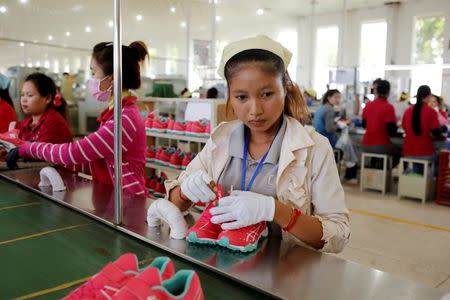 Women work on the production line at Complete Honour Footwear Industrial, a footwear factory owned by a Taiwan company, in Kampong Speu, Cambodia, July 4, 2018. REUTERS/Ann Wang