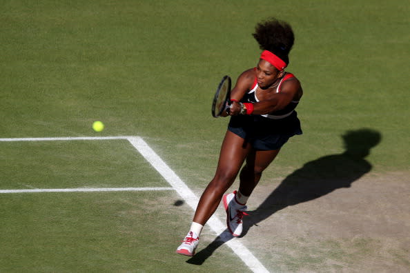 Serena Williams of the United States returns a shot against Victoria Azarenka of Belarus in the Semifinal of Women's Singles Tennis on Day 7 of the London 2012 Olympic Games at Wimbledon on August 3, 2012 in London, England. (Photo by Clive Brunskill/Getty Images)