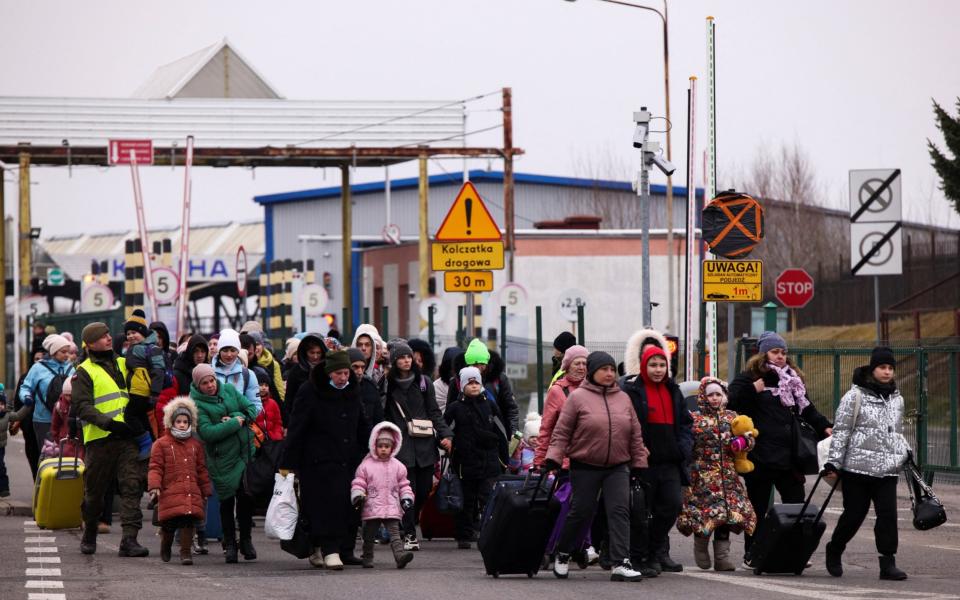 People from Ukraine arrive to Poland after crossing the Polish-Ukrainian border on Friday  - Kuba Stezycki/Reuters