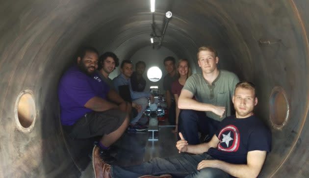 Members of UW’s Hyperloop team are ready for the pod races. On the left side of the pod track, from front to back, are David Coven, CJ Grijalva, Max Pfeiffer and Jasdip Singh. On the right, from front to back: Ted Coleman, Luke Marcoe, Nicole Lambert and Isaac Perrin. (UWashington Hyperloop Photo)