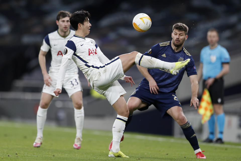 Tottenham's Son Heung-min controls the ball in front of Dinamo Zagreb's Bruno Petkovic, right, during the Europa League round of 16, first leg, soccer match between Tottenham Hotspur and Dinamo Zagreb at the Tottenham Hotspur Stadium in London, England, Thursday, March 11, 2021. (AP photo/Alastair Grant, Pool)