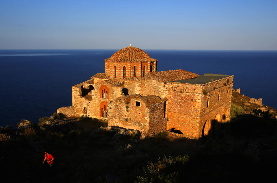 A Belgian tourist walks atop the medieval fortress of Monemvasia in front of the 12th century church of Agia Sophia Yannis Behrakis / Reuters