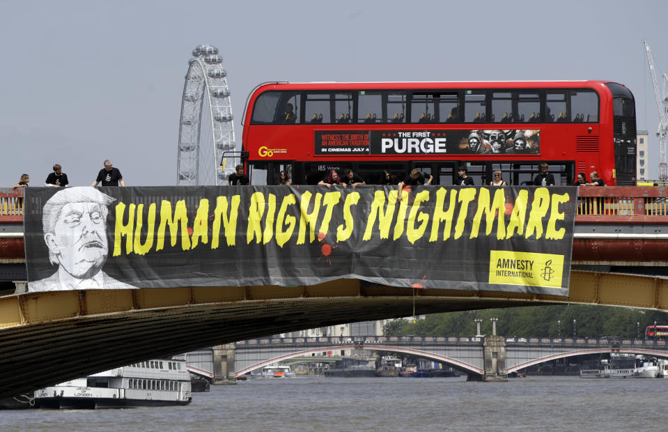 <p>A giant “Human Rights Nightmare” banner is unfurled by Amnesty International activists across the river Thames on Vauxhall Bridge to protest against the visit of U.S. President Donald Trump, in London, July 12, 2018. (Photo: Luca Bruno/AP) </p>