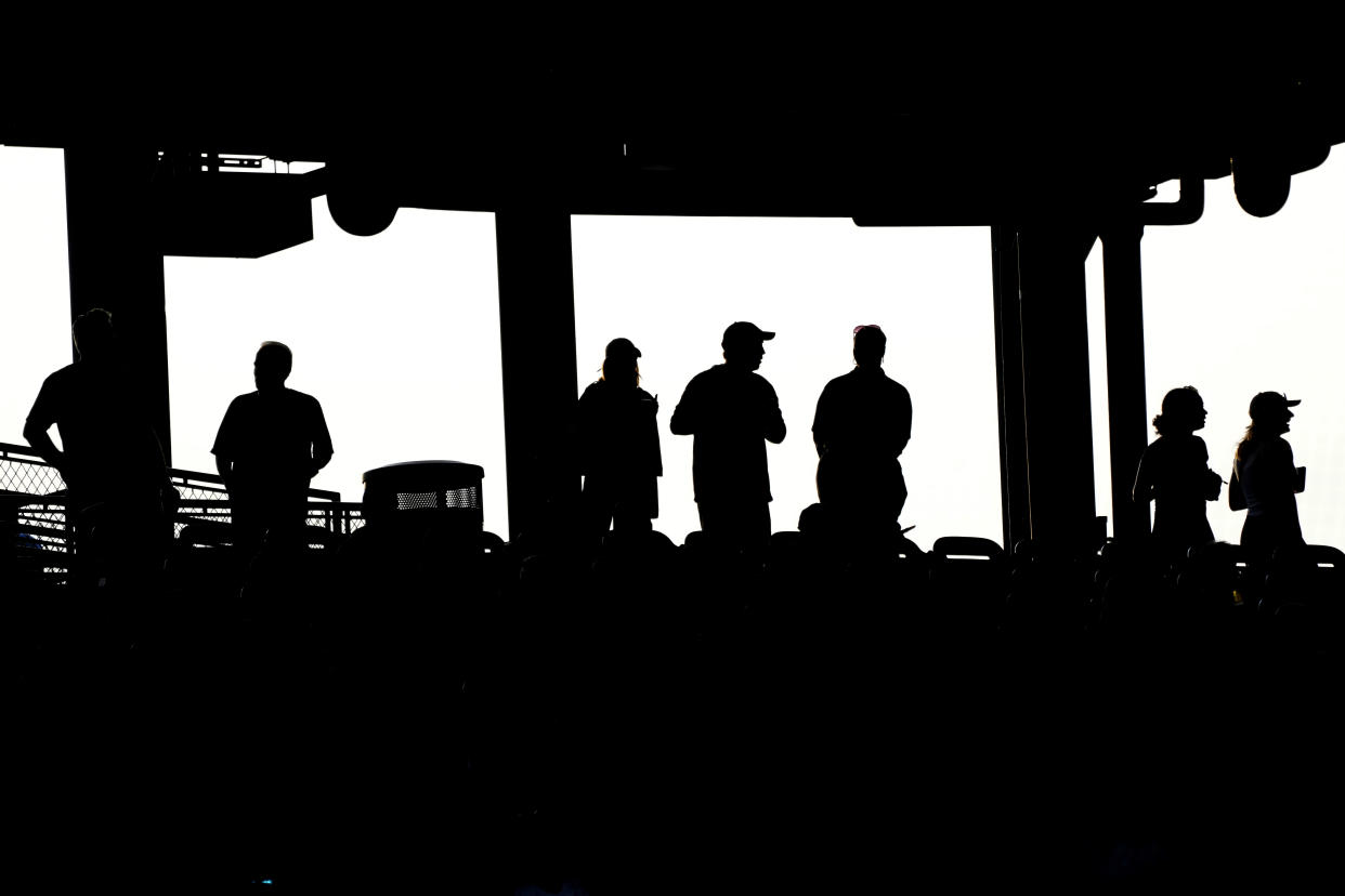 Baseball fans watch during the first inning of a baseball game between the Seattle Mariners and the Chicago Cubs in Chicago, Tuesday, April 11, 2023. (AP Photo/Nam Y. Huh)