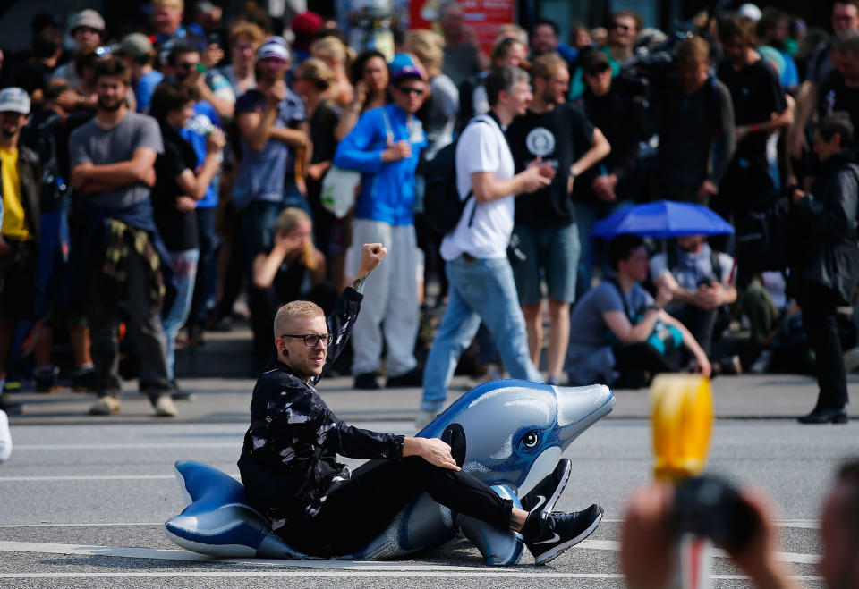 <p>A protester sits on an inflatable toy during a demonstration at the G20 summit in Hamburg, Germany, July 7, 2017. (Photo: Hannibal Hanschke/Reuters) </p>