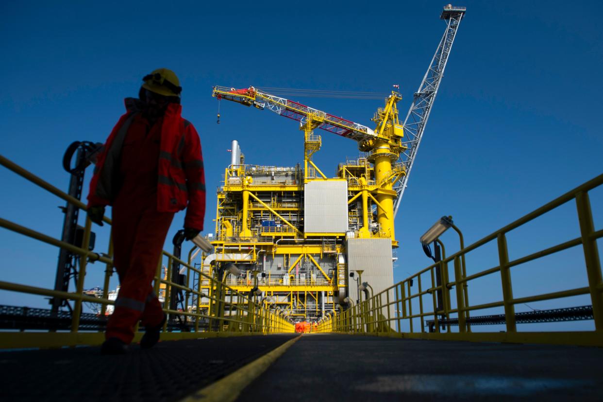 An employee walks along the Total Culzean platform on the North Sea, about 45 miles (70 kilometres) east of the Aberdeen, Europe's self-proclaimed oil capital on Scotland's northeast coast, on April 8, 2019. - Deep beneath the cold waters of the North Sea lies what French energy giant Total hopes will help feed Britain's voracious appetite for gas.  Total forecasts that the Culzean field, located more than 15,000 metres under the seabed halfway between Scotland and Norway, will cover five percent of Britain's gas requirements. (Photo by ANDY BUCHANAN / AFP) / TO GO WITH AFP STORY by Joseph SOTINEL        (Photo credit should read ANDY BUCHANAN/AFP via Getty Images)