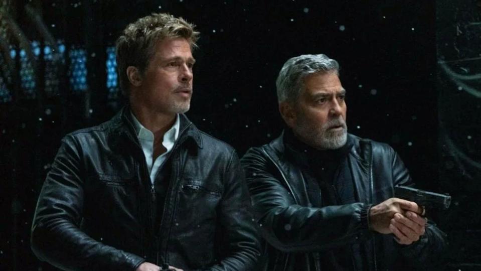 Brad Pitt and George Clooney are unlikely allies in Wolfs. (Apple TV+/Alamy)