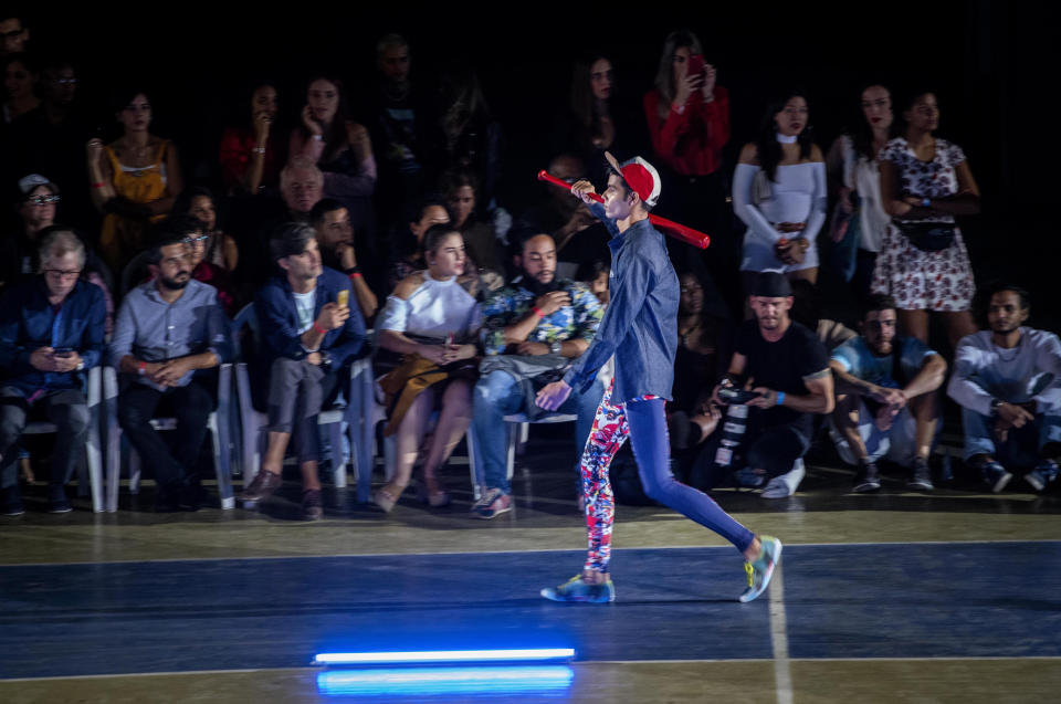 A model wears a creation from "Clandestina," the first Cuban independent urban fashion brand, during a launch for the 2020 collection called Sports Glories in Havana, Cuba, Friday, Nov. 22, 2019. (AP Photo/Ramon Espinosa)