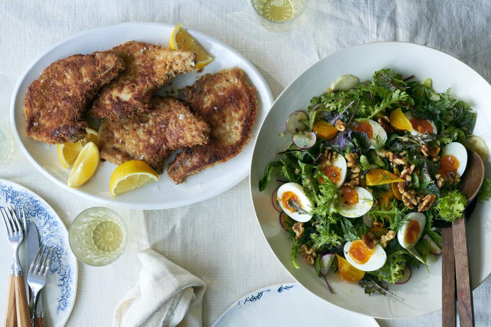 Chuletas de cerdo empanizadas y fritas en sartén y una ensalada de primavera con hierbas dulces, huevo y nueces de Castilla, en Nueva York, el 23 de marzo de 2021. Estilista de alimentos: Simon Andrews. (David Malosh/The New York Times)