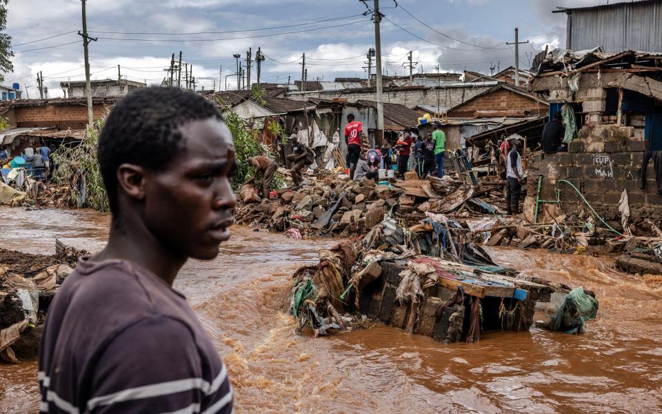 A man stands next to an area were houses were destroyed by floods following torrential rains at the Mathare informal settlement in Nairobi,