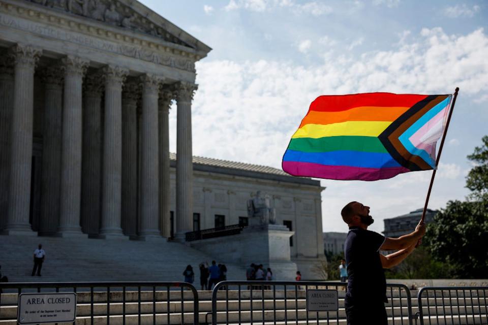 A supporter of same-sex marriage waves a pride flag in front of the U.S. Supreme Court to celebrate the eighth anniversary of the Obergefell v. Hodges decision. <a href="https://www.gettyimages.com/detail/news-photo/same-sex-marriage-supporter-vin-testa-of-washington-dc-news-photo/1502430450?adppopup=true" rel="nofollow noopener" target="_blank" data-ylk="slk:Anna Moneymaker/Getty Images;elm:context_link;itc:0;sec:content-canvas" class="link ">Anna Moneymaker/Getty Images</a>