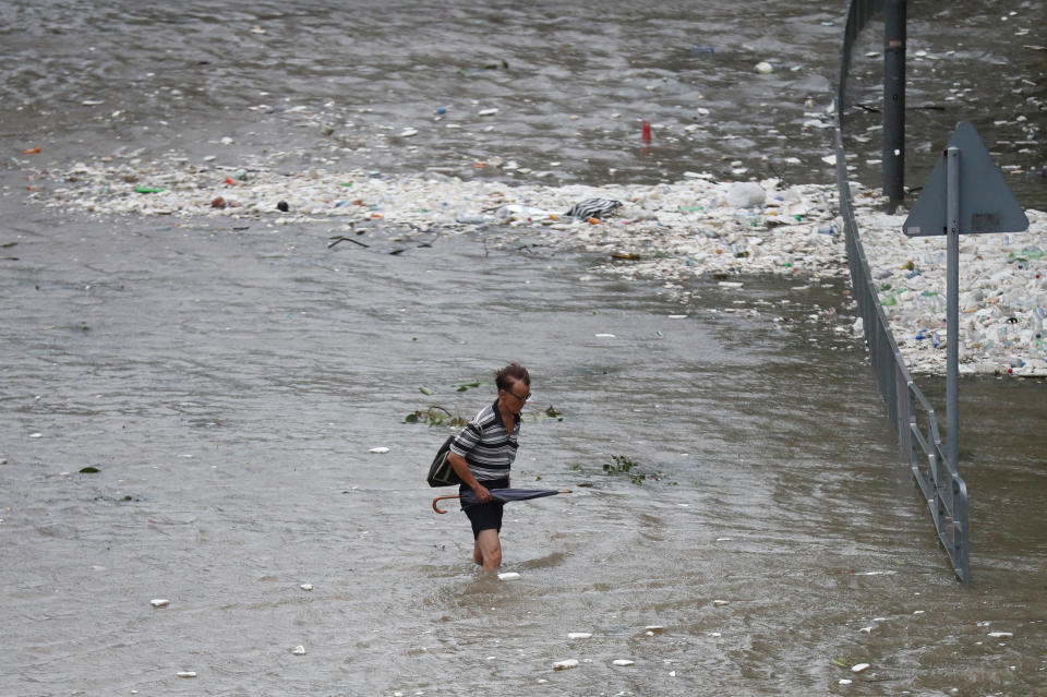 <p>A man walks through a flooded street as Typhoon Hato hits Hong Kong, China, Aug.23, 2017. (Photo: Tyrone Siu/Reuters) </p>