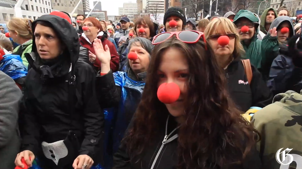 A rally of people are wearing clown noses