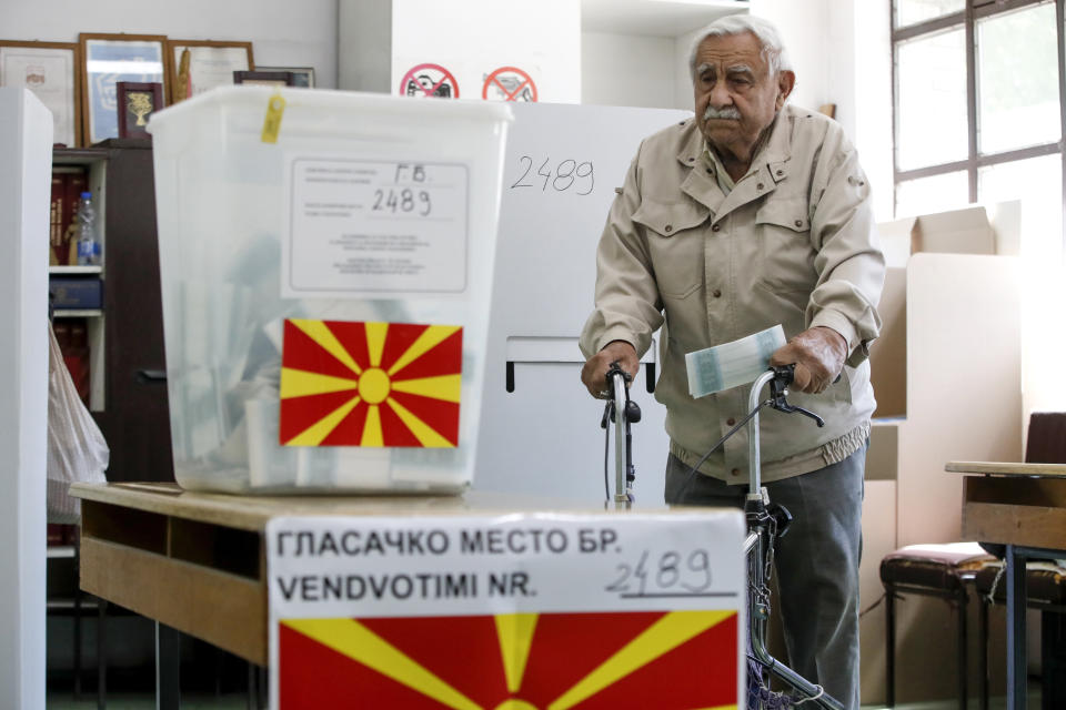 An elderly man comes from voting booth to cast his ballot for the presidential election at a polling station in Skopje, North Macedonia, on Wednesday, April 24, 2024. People are lining up at pools to cast their votes in a peaceful atmosphere, hoping that the next president will be able to bring the country into the European Union. (AP Photo/Boris Grdanoski)