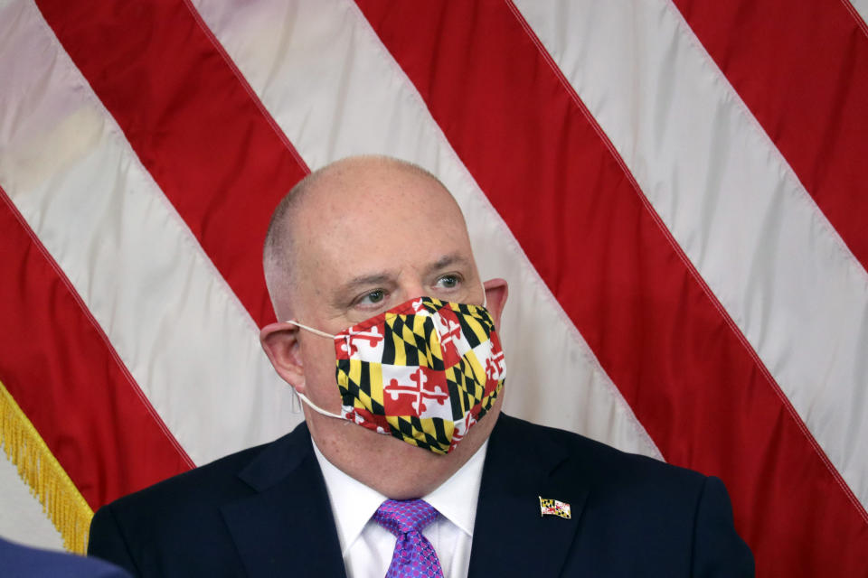 Maryland Gov. Larry Hogan wears a mask with a pattern of the state flag of Maryland during a news conference on Friday, April 24, 2020 in Annapolis, Md., where he discussed plans to gradually ease restrictions on businesses and activities that have been in place because of the coronavirus. (AP Photo/Brian Witte)