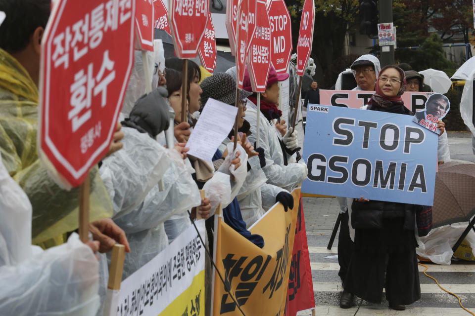 A protester holds a placard during a rally to oppose a visit by U.S. Secretary for Defense Mark Esper in front of the Defense Ministry in Seoul, South Korea, Friday, Nov. 15, 2019. The sign reads "We demand to abolish the General Security of Military Information Agreement, or GSOMIA, an intelligence-sharing agreement between South Korea and Japan." (AP Photo/Ahn Young-joon)