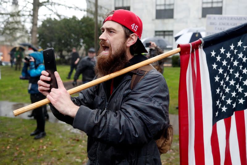 A supporter of U.S. President Donald Trump confronts police at a rally in support of Trump at the Oregon State Capitol in Salem