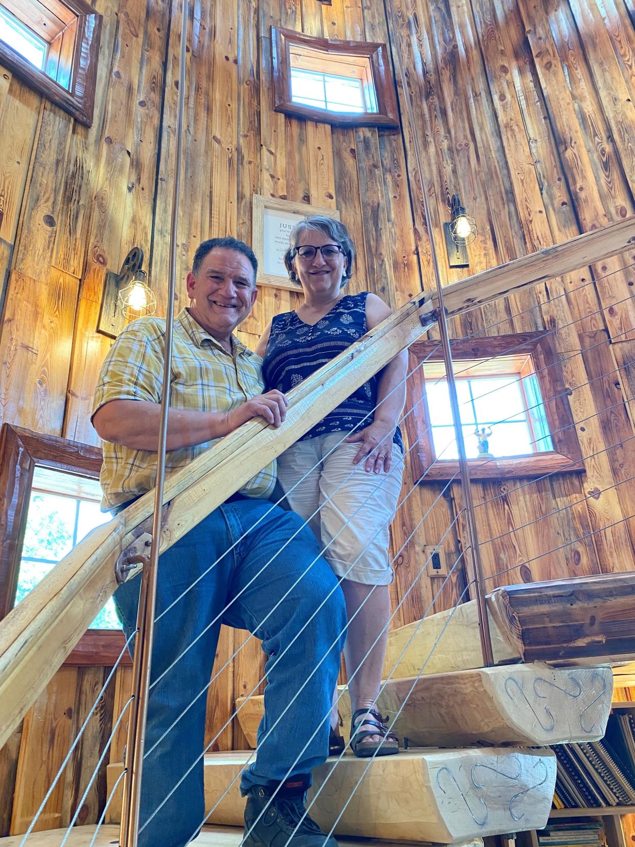 Bob and Laura Kulp pose in the spiral staircase that leads to their Airbnb property that takes up the second floor of a barn. Bob Kulp built the staircase inside a silo that he dismantled on its original farm and moved to the property in the Lincoln County town of Rock Falls.