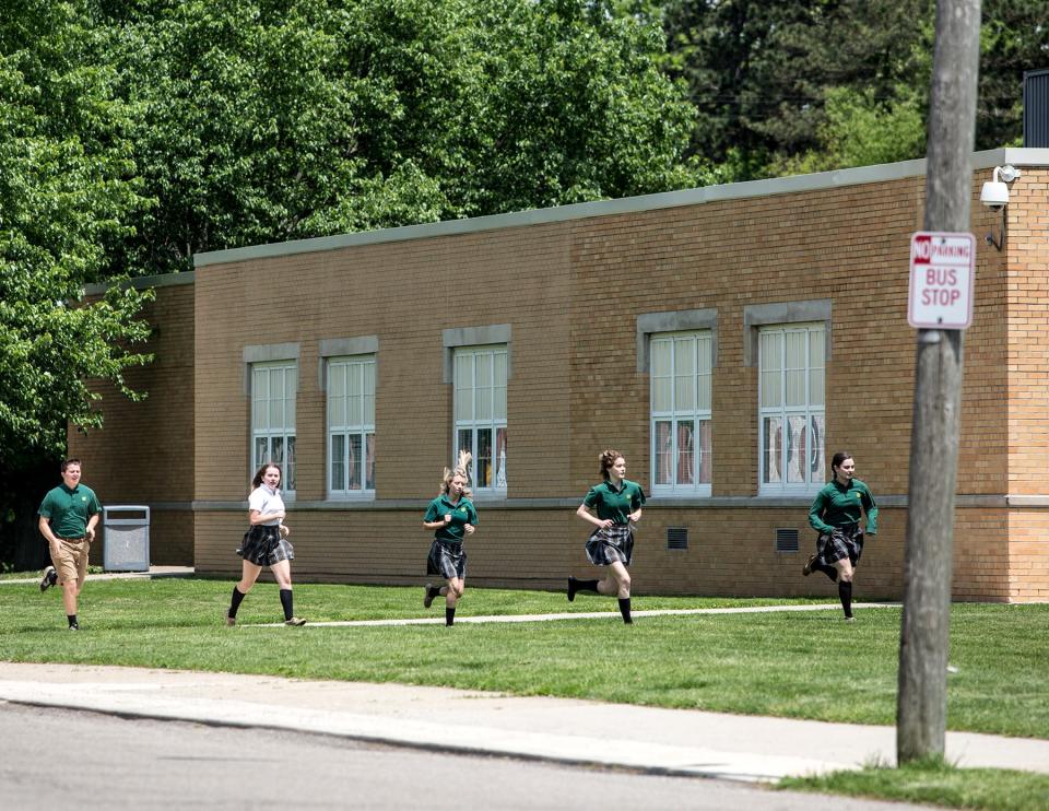 Newark Catholic students run from their school to Wilson Middle School during an active-shooter drill in Newark, Ohio.