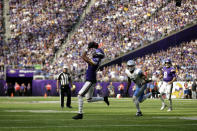 Minnesota Vikings wide receiver Justin Jefferson (18) catches a pass ahead of Detroit Lions safety DeShon Elliott (5) during the second half of an NFL football game, Sunday, Sept. 25, 2022, in Minneapolis. (AP Photo/Andy Clayton-King)