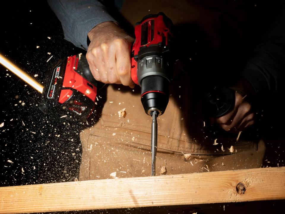 cordless drill powering through wood