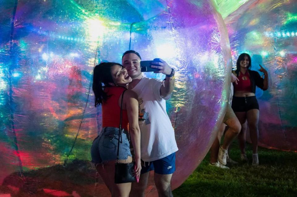 Savannah Montgomery and Adrian Valencia, of Merced, take a selfie in front of bubble installations on the first day of the Sol Blume R&B festival on Saturday.