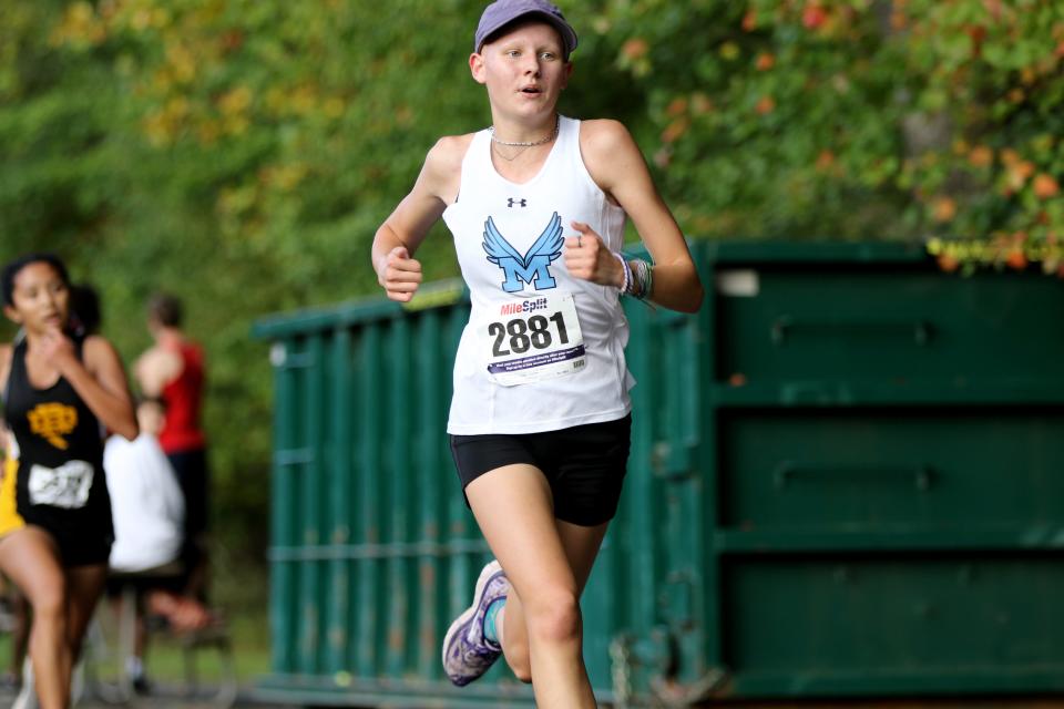 Zoe Merryman, of Mahwah, passes Isabella Gabay of River Dell, in the last 100 meters, at Darlington County Park, in Mahwah. Merryman came away with a third place finish and Gabay grabbing fourth. Thursday, October 14, 2021