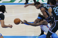 Oklahoma City Thunder forward Luguentz Dort (5) passes in front of Sacramento Kings guard Buddy Hield (24) in the first half of an NBA basketball game Tuesday, May 4, 2021, in Oklahoma City. (AP Photo/Sue Ogrocki)